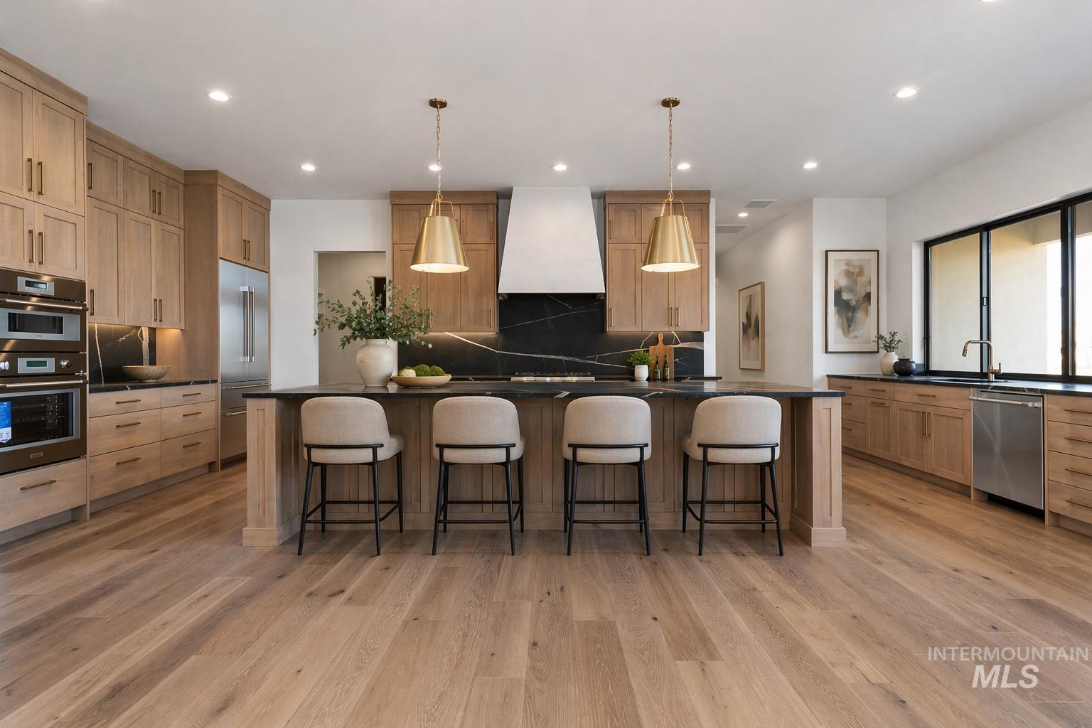 539 Century Avenue Middleton, ID 83644 - Photo 14 of 50 Kitchen with a breakfast bar area, a spacious island, decorative light fixtures, stainless steel appliances, and light wood finished floors