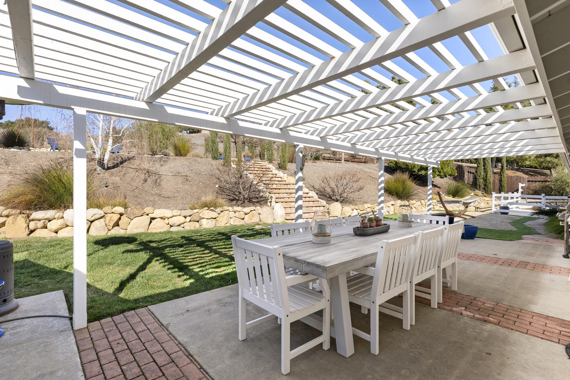 1855 Ringsted Drive Solvang, CA 93463 - Photo 24 of 30 a view of a patio with a table and chairs and potted plants