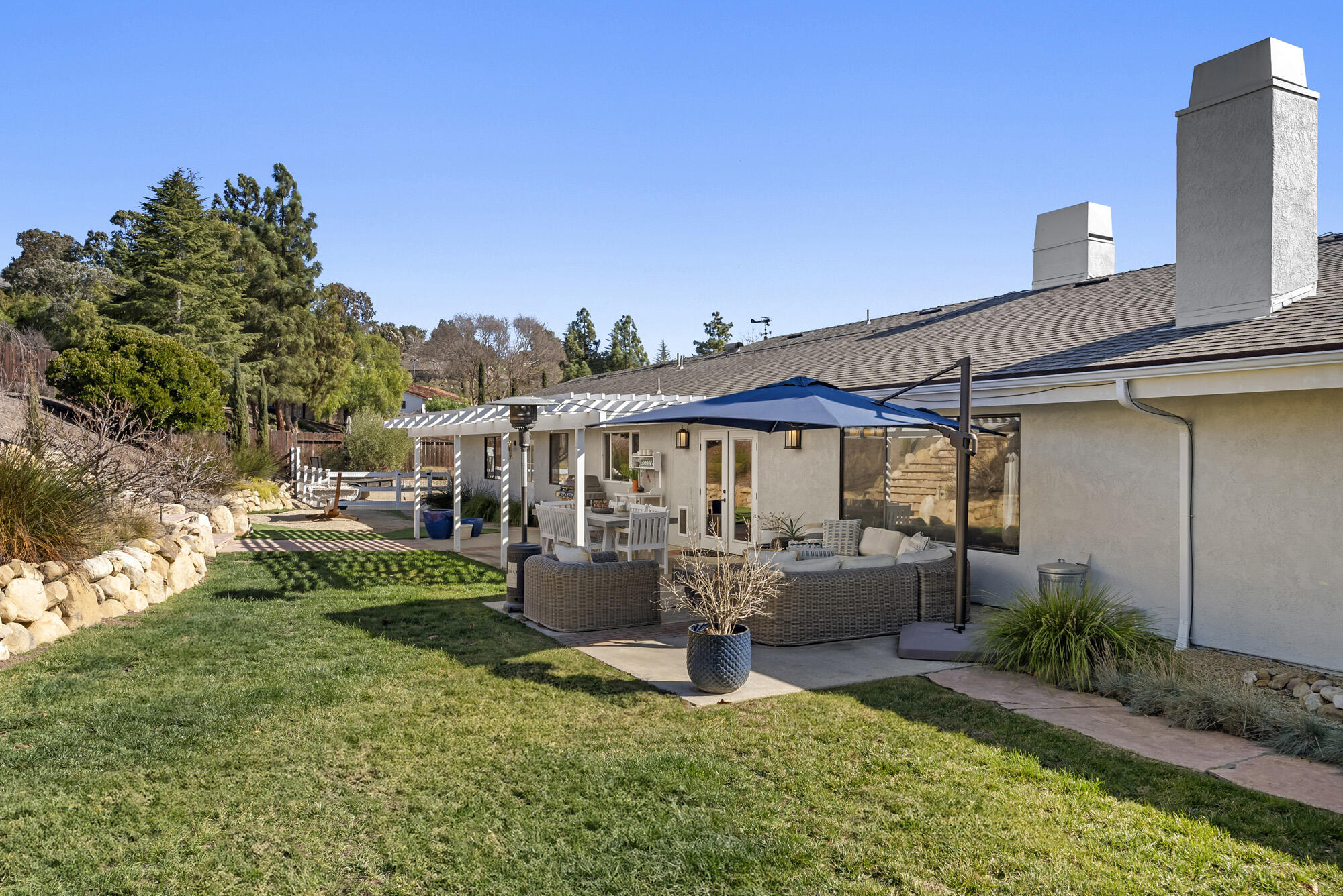 1855 Ringsted Drive Solvang, CA 93463 - Photo 25 of 30 a view of a patio with table and chairs potted plants with wooden fence