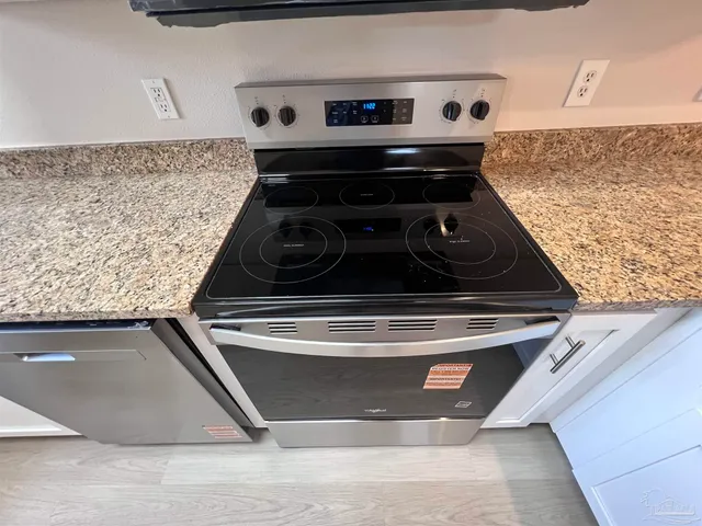 a stove top oven sitting inside of a kitchen