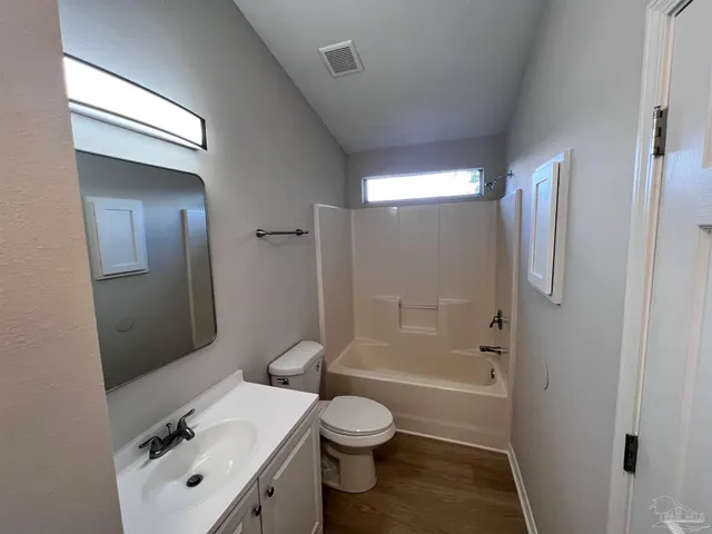 a bathroom with a toilet a sink and shower