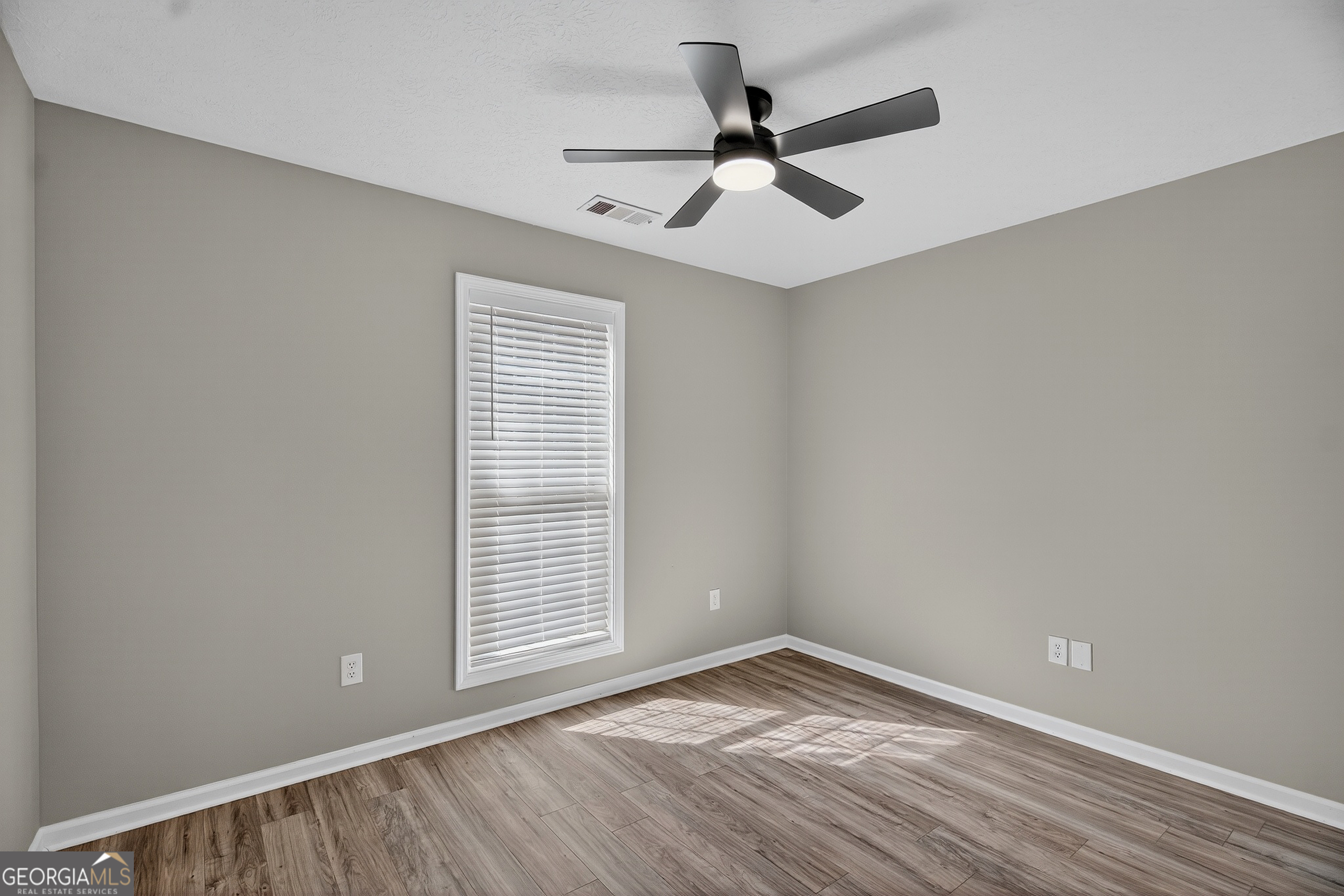 105 Ridgefield Drive LaGrange, GA 30241 - Photo 14 of 18 a view of empty room with wooden floor and fan