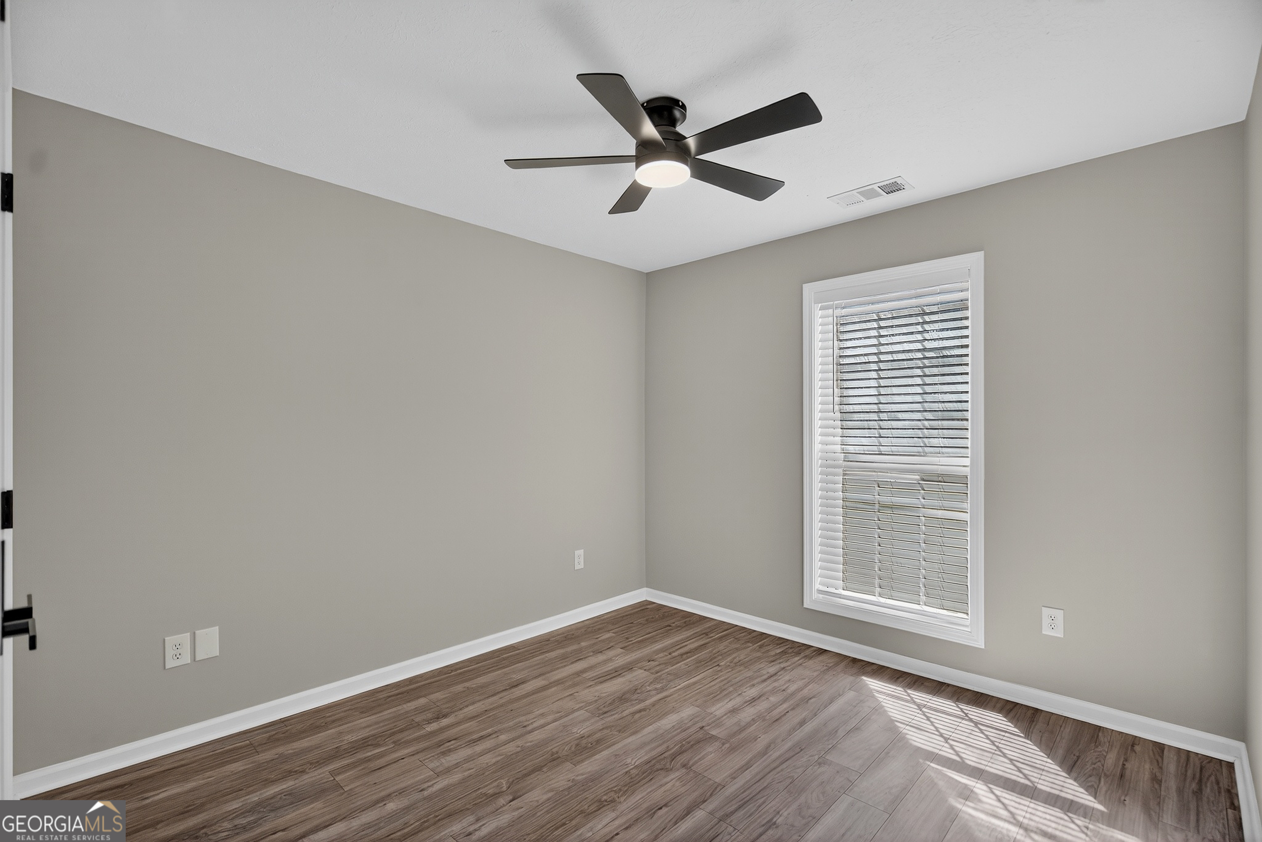 105 Ridgefield Drive LaGrange, GA 30241 - Photo 16 of 18 wooden floor in an empty room with a window
