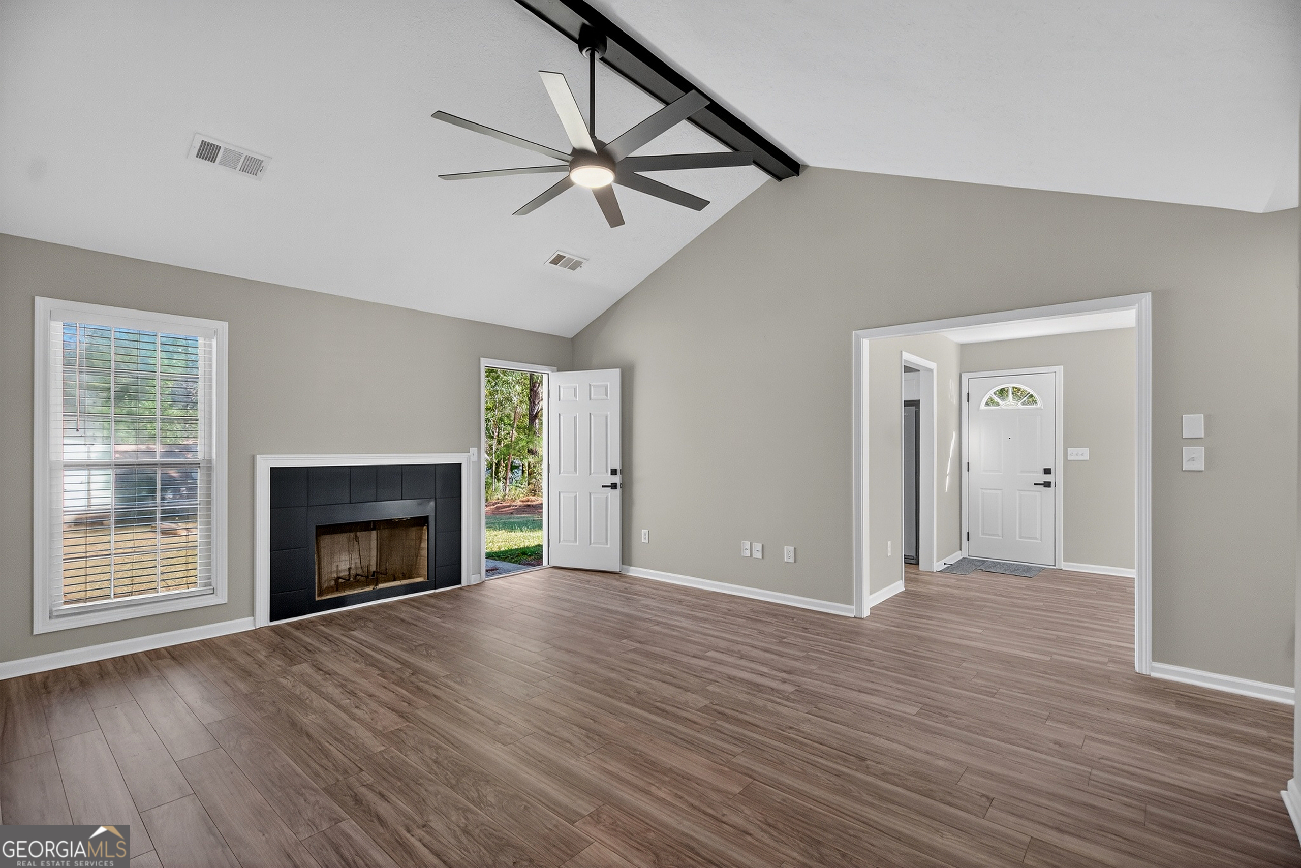 105 Ridgefield Drive LaGrange, GA 30241 - Photo 5 of 18 a view of an empty room with wooden floor fireplace and a window