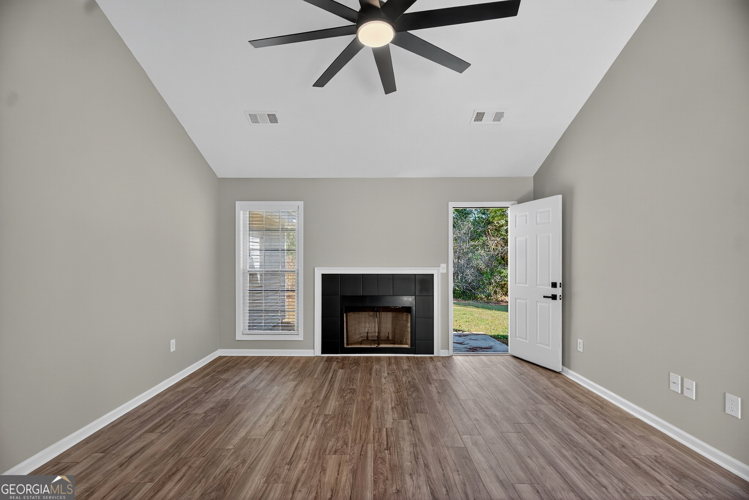 105 Ridgefield Drive LaGrange, GA 30241 - Photo 6 of 18 a view of an empty room with a fireplace and a window