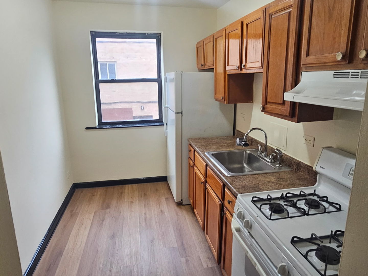 6820 South Perry Avenue Chicago, IL 60621 - Photo 2 of 7 a kitchen that has a sink and a stove