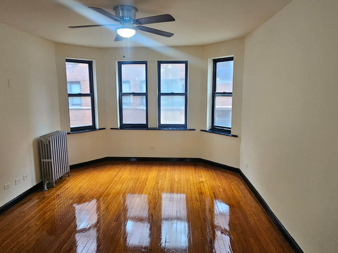 6820 South Perry Avenue Chicago, IL 60621 - Photo 4 of 7 wooden floor in an empty room with a window