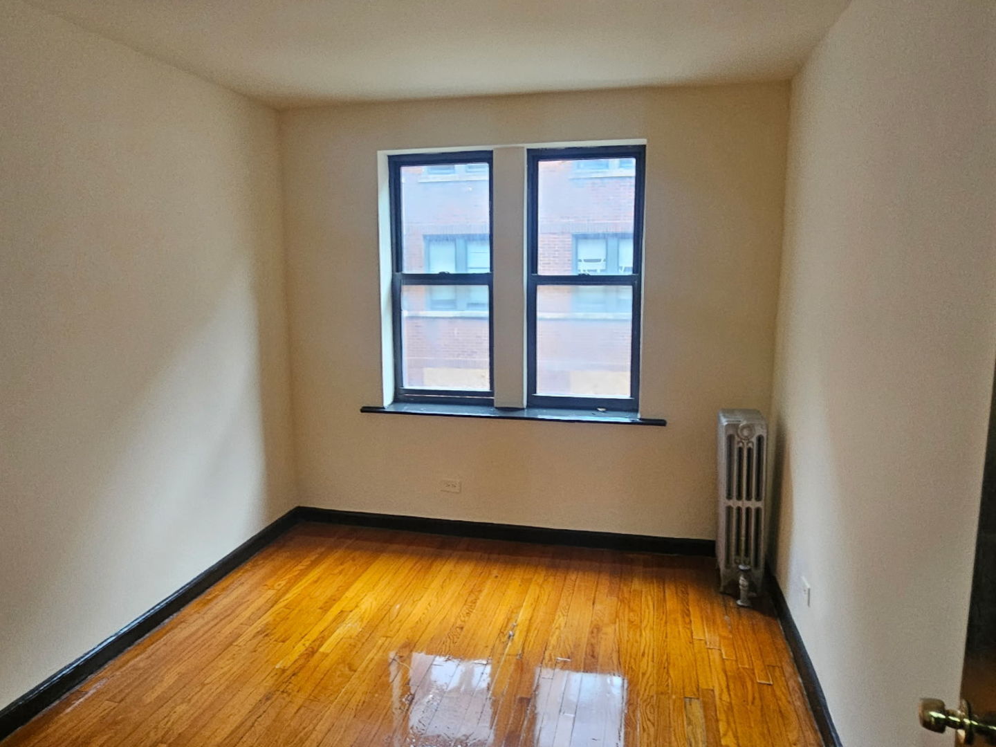 6820 South Perry Avenue Chicago, IL 60621 - Photo 5 of 7 an empty room with wooden floor and windows