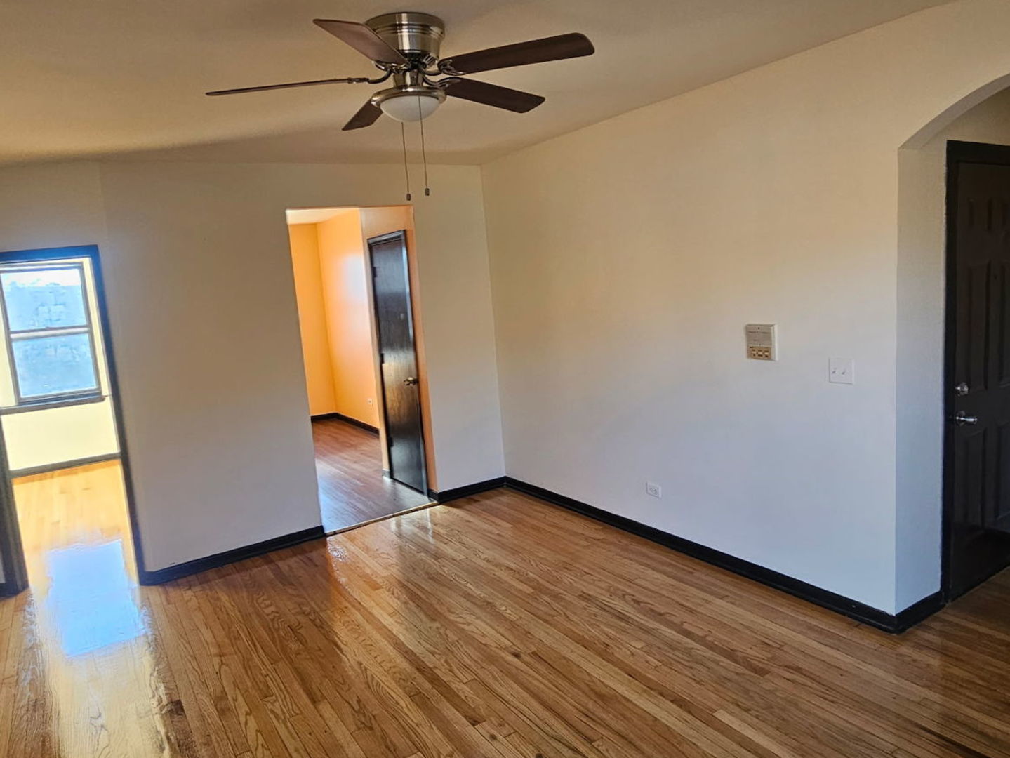 6820 South Perry Avenue Chicago, IL 60621 - Photo 6 of 7 a view of an empty room with wooden floor and a window