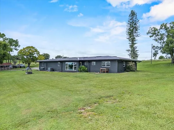a view of a big house with a big yard