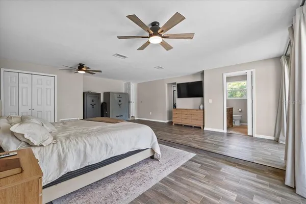 a spacious bedroom with a bed and a table