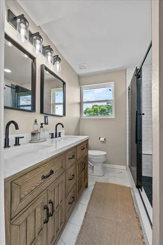 a bathroom with a shower and a glass door