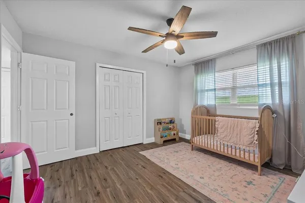 a bedroom with furniture and wooden floor