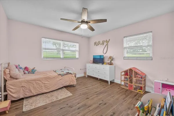a living room with furniture and a baby crib