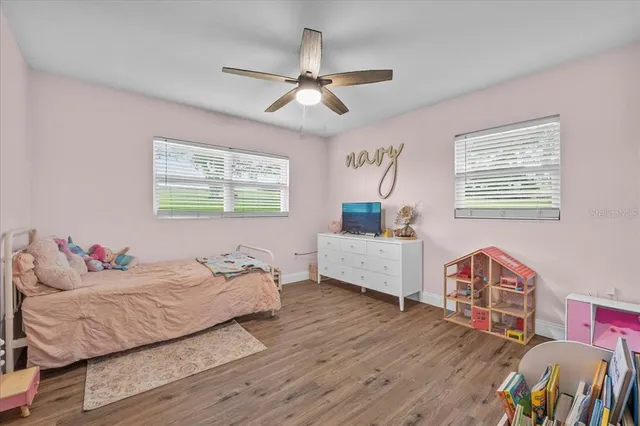 a living room with furniture and a baby crib