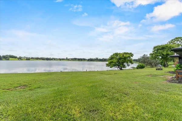 a view of a lake with houses in the back