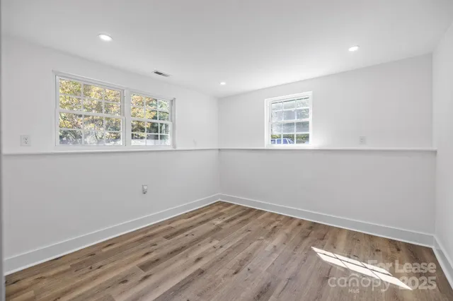 a view of a room with wooden floor and window