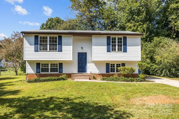 a front view of house with yard and green space
