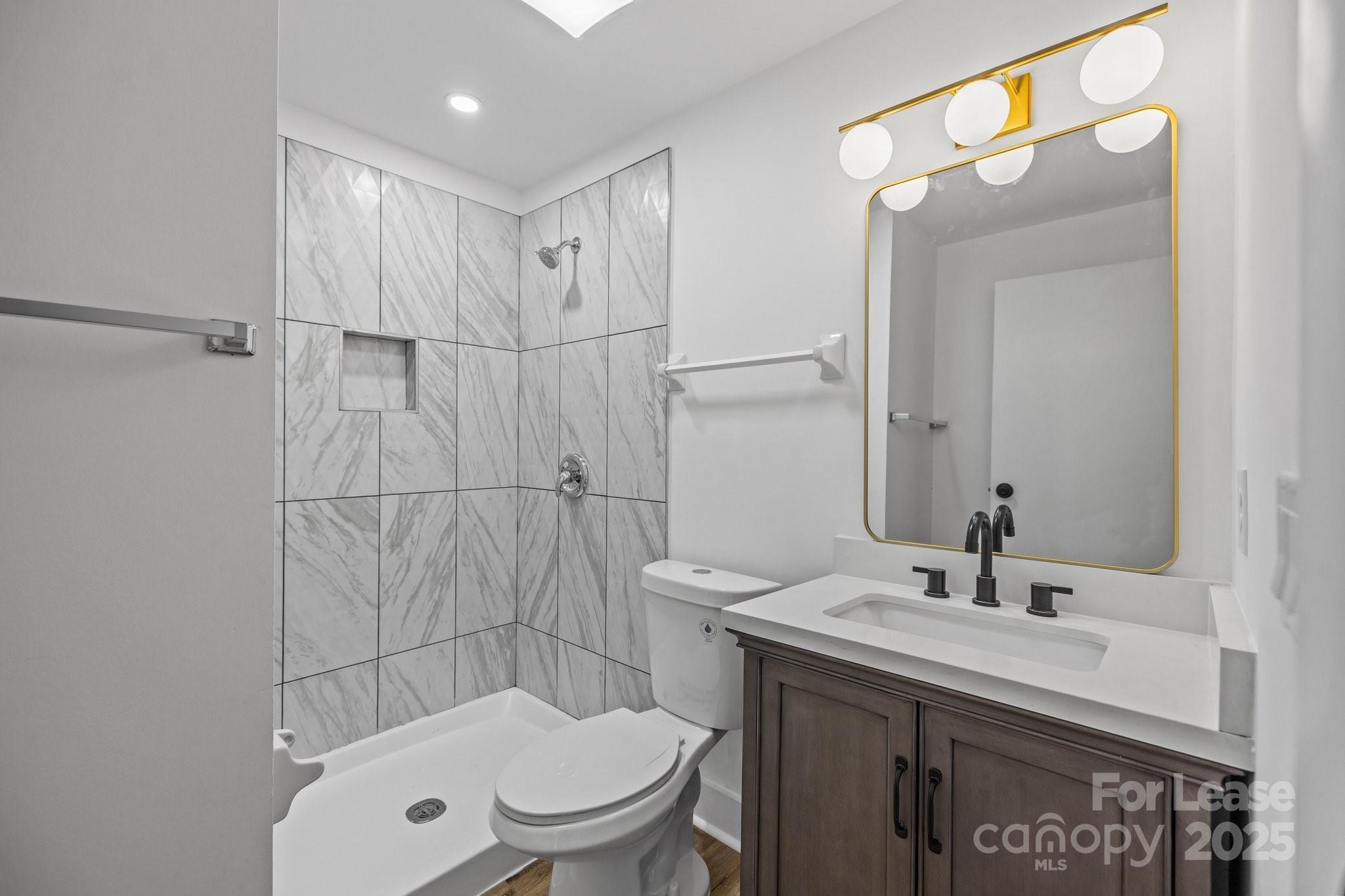 7120 Clear Crossing Lane Mint Hill, NC 28227 - Photo 23 of 27 a bathroom with a sink a toilet and shower