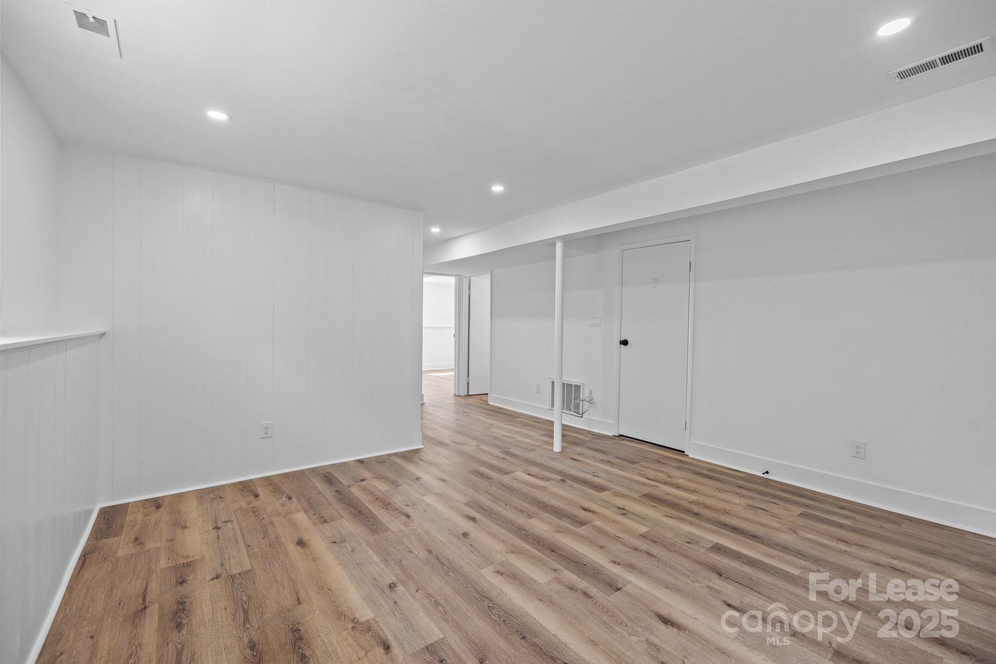 7120 Clear Crossing Lane Mint Hill, NC 28227 - Photo 25 of 27 a view of an empty room with wooden floor