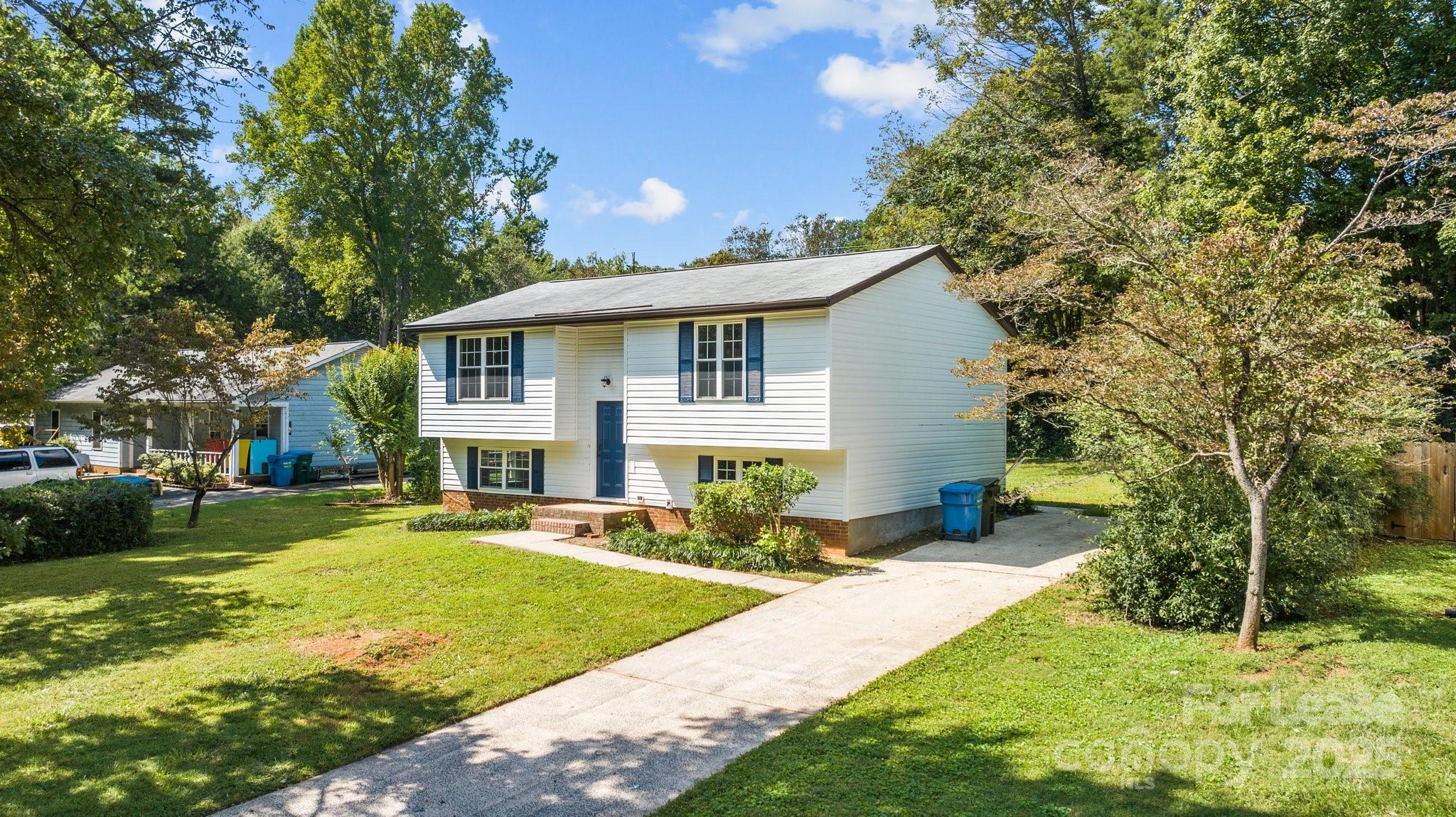 7120 Clear Crossing Lane Mint Hill, NC 28227 - Photo 27 of 27 a front view of a house with a yard and trees