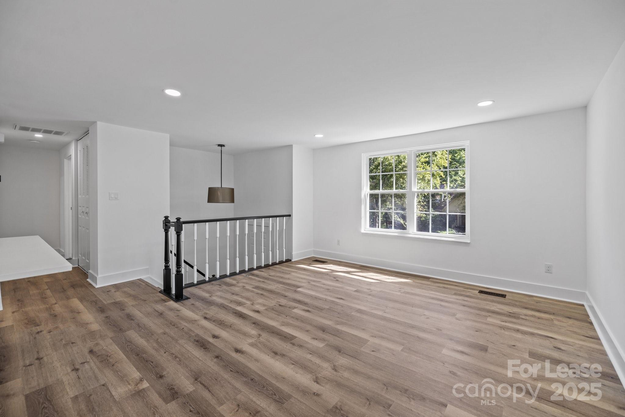 7120 Clear Crossing Lane Mint Hill, NC 28227 - Photo 4 of 27 an empty room with wooden floor and windows
