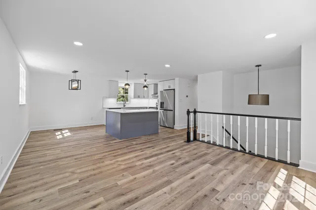 a view of kitchen and kitchen with furniture wooden floor