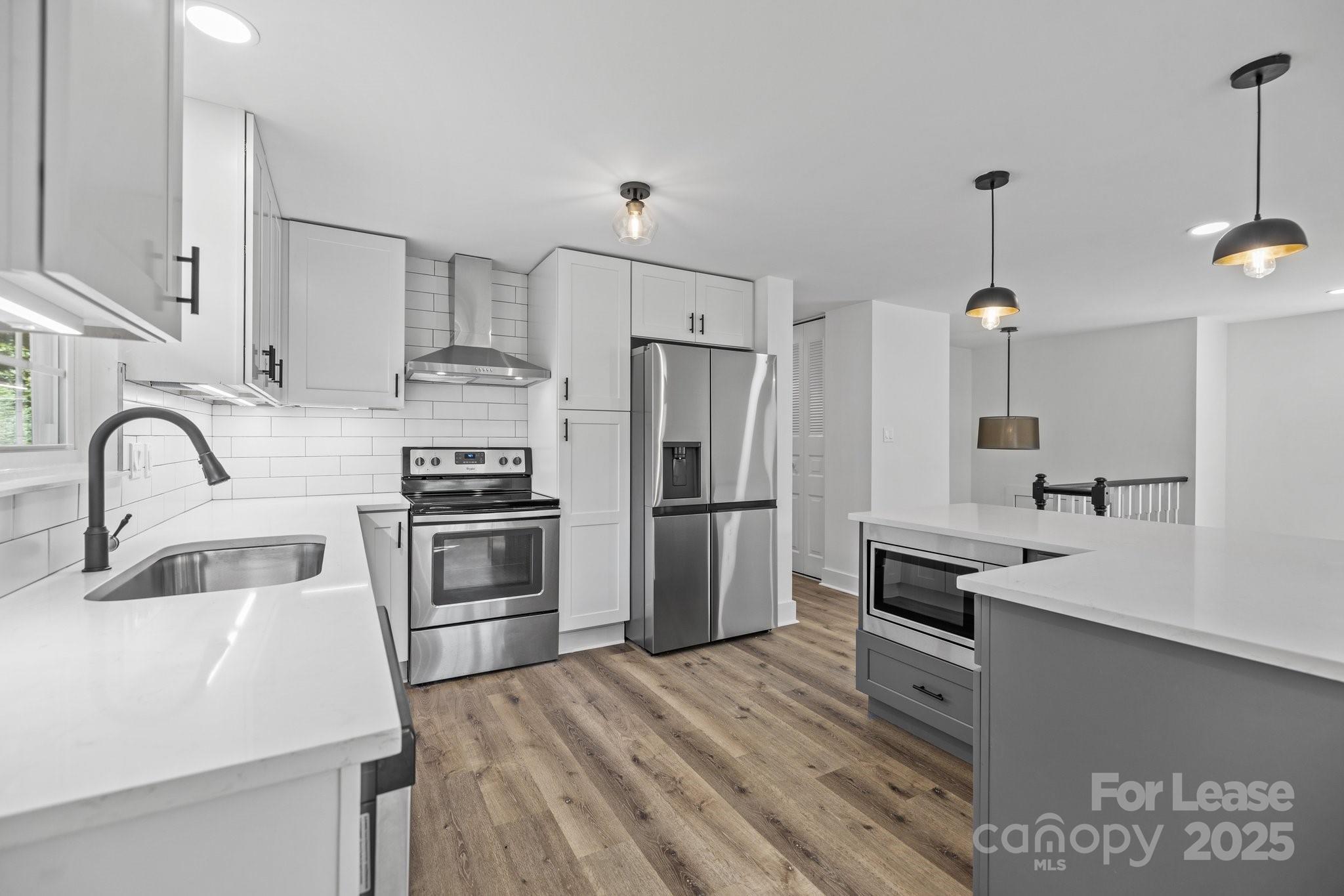 7120 Clear Crossing Lane Mint Hill, NC 28227 - Photo 8 of 27 a kitchen with kitchen island stainless steel appliances a sink stove and refrigerator