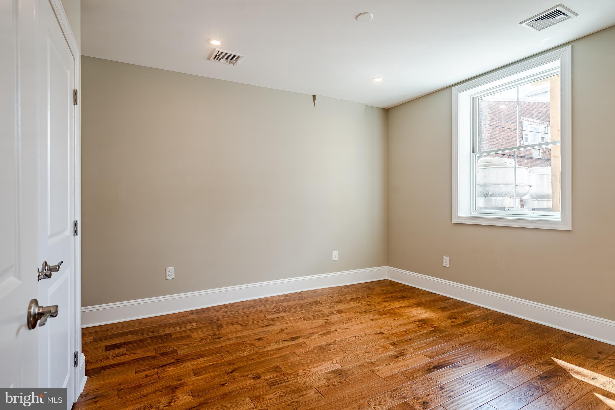 226 Bridge Street, Unit 2 Phoenixville, PA 19460 - Photo 14 of 25 a view of empty room with wooden floor and fan