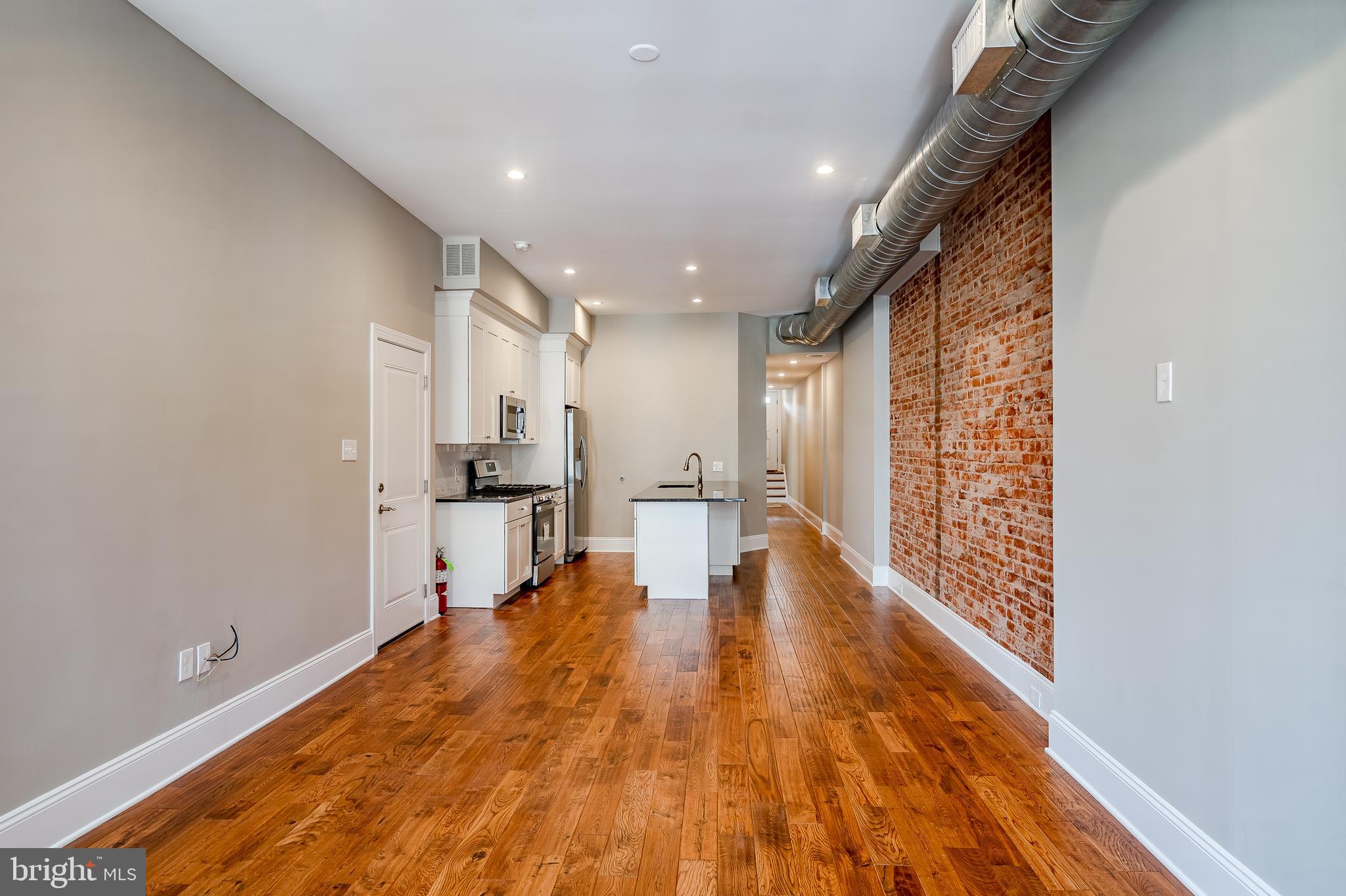 226 Bridge Street, Unit 2 Phoenixville, PA 19460 - Photo 9 of 25 a view of empty room with wooden floor