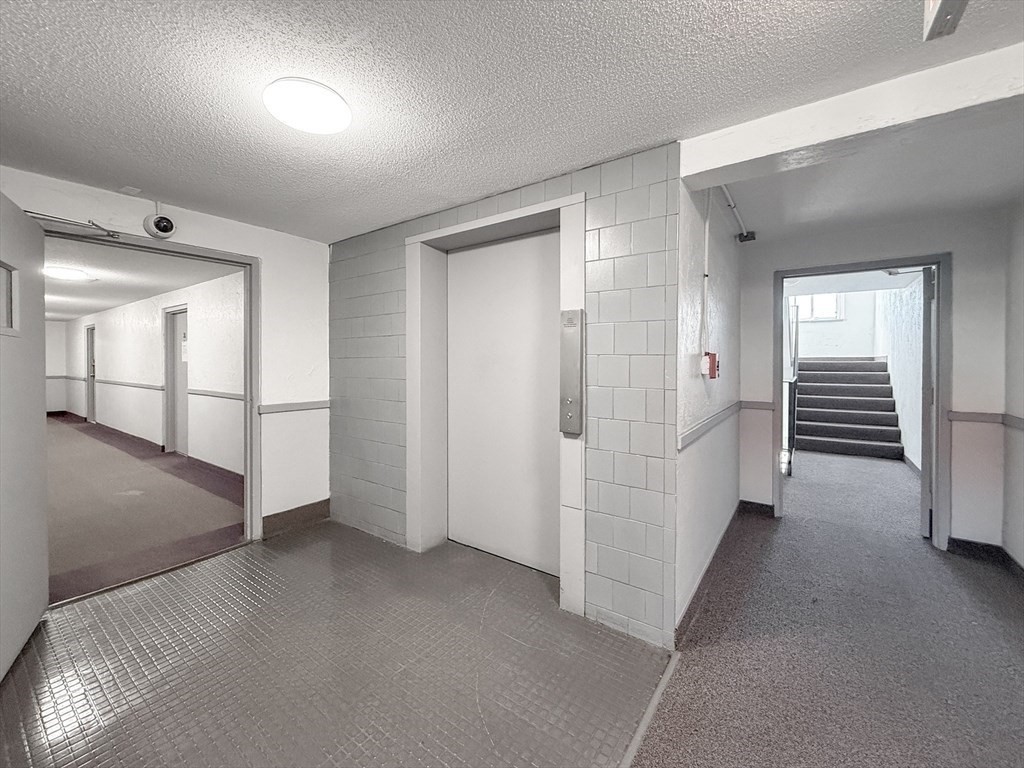 175 Ward Street, Unit 35 Revere, MA 02151 - Photo 11 of 19 a view of a hallway with wooden shelves