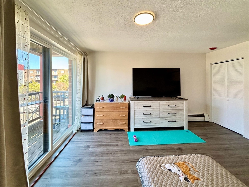 175 Ward Street, Unit 35 Revere, MA 02151 - Photo 2 of 19 a living room with furniture and a flat screen tv