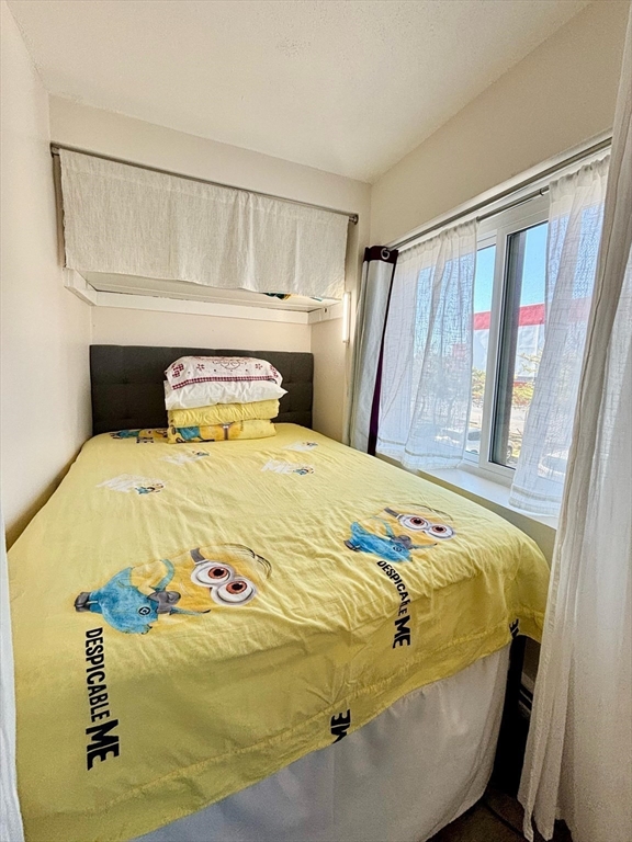 175 Ward Street, Unit 35 Revere, MA 02151 - Photo 5 of 19 a bedroom with a bed and wooden floor