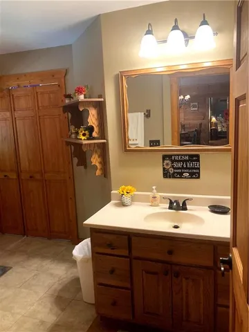 a bathroom with a double vanity sink and a mirror
