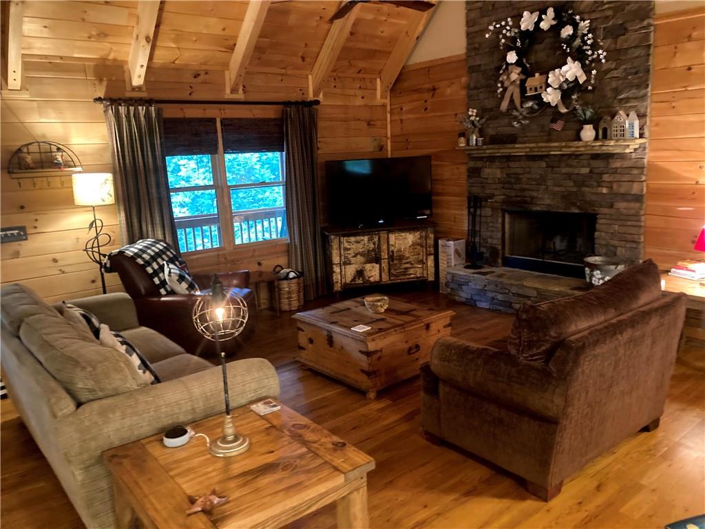 105 Ranch Mountain Court Dahlonega, GA 30533 - Photo 2 of 70 a living room with furniture a flat screen tv and a fireplace