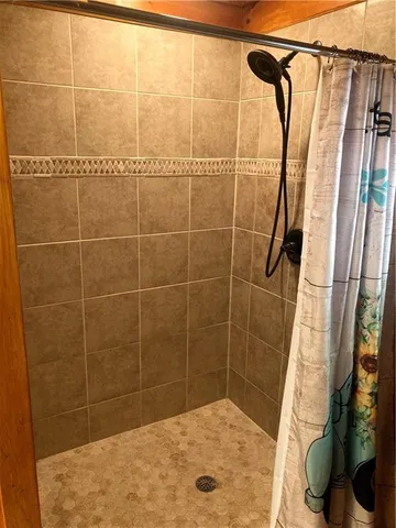 a bathroom with a shower curtain and a curtain