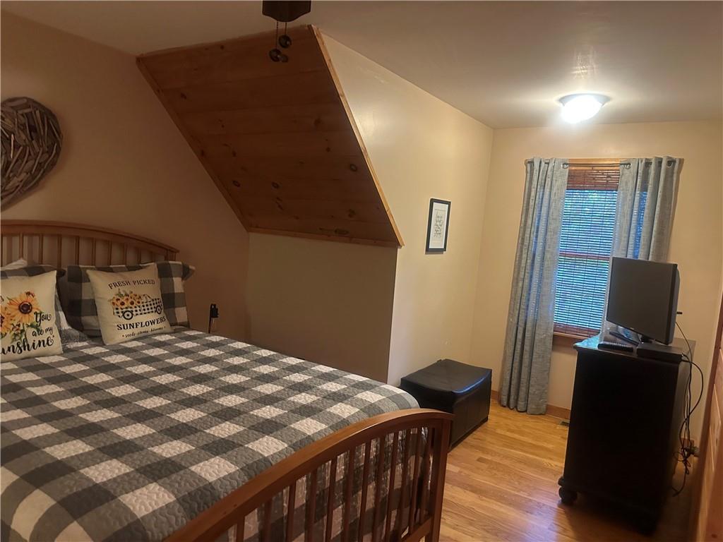 105 Ranch Mountain Court Dahlonega, GA 30533 - Photo 28 of 70 a bedroom with a bed and wooden floor