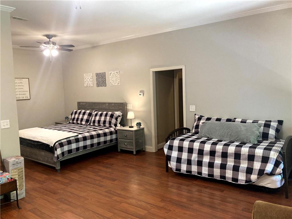 105 Ranch Mountain Court Dahlonega, GA 30533 - Photo 37 of 70 a bedroom with a bed and wooden floor