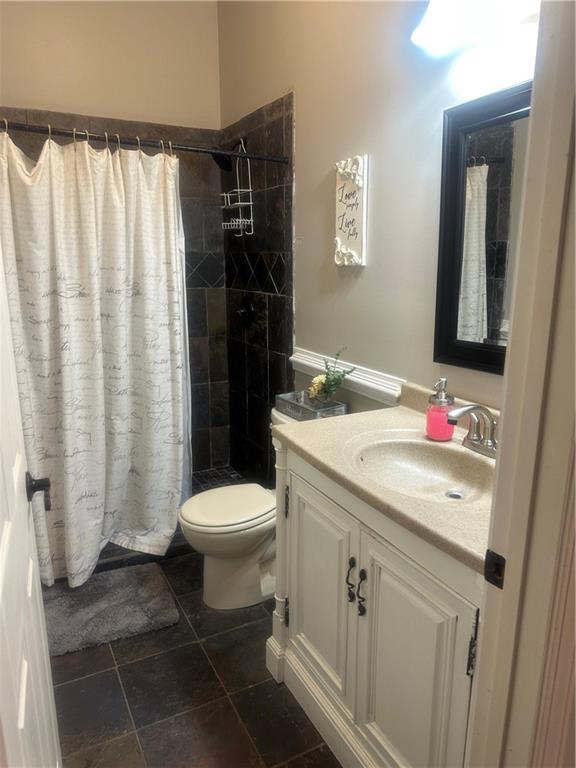 105 Ranch Mountain Court Dahlonega, GA 30533 - Photo 39 of 70 a bathroom with a sink toilet and shower