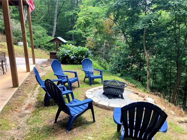 an aerial view of a house with a yard and outdoor seating