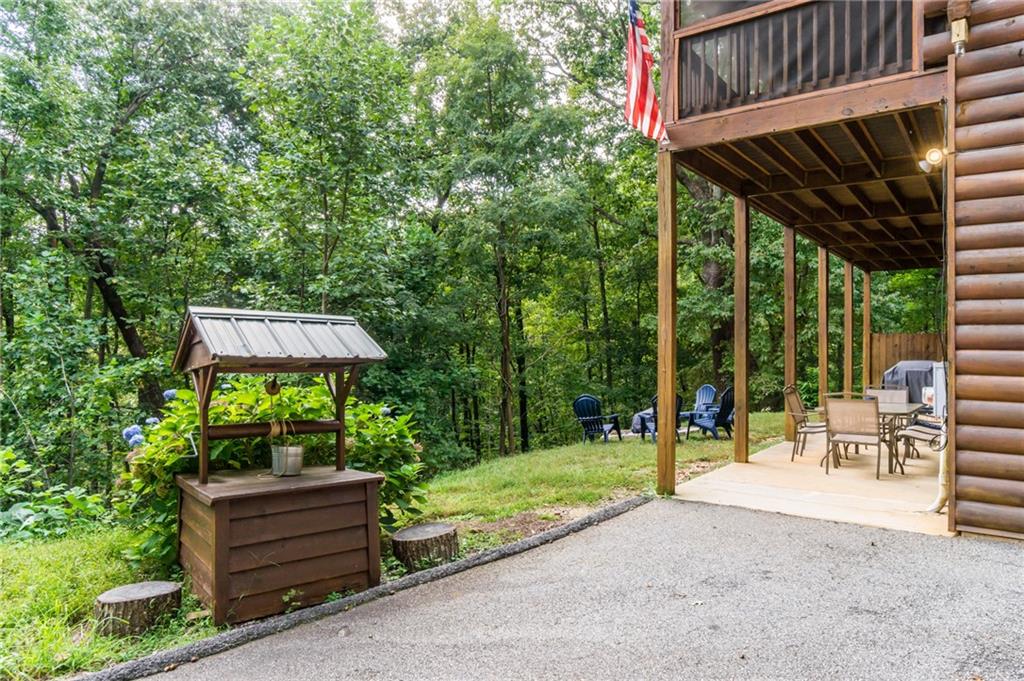 105 Ranch Mountain Court Dahlonega, GA 30533 - Photo 50 of 70 a backyard of a house with a garden and outdoor seating
