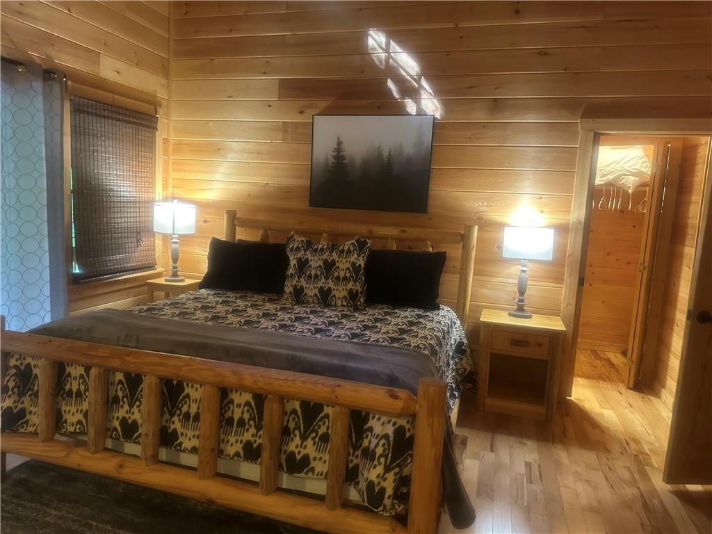 105 Ranch Mountain Court Dahlonega, GA 30533 - Photo 10 of 70 a bedroom with a bed and wooden floor