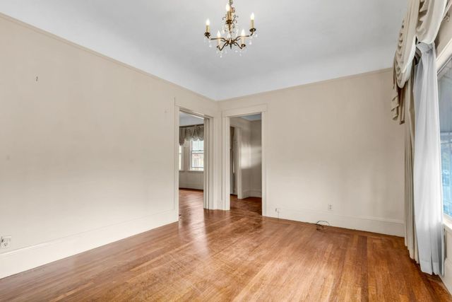a view of a room with wooden floor and fireplace