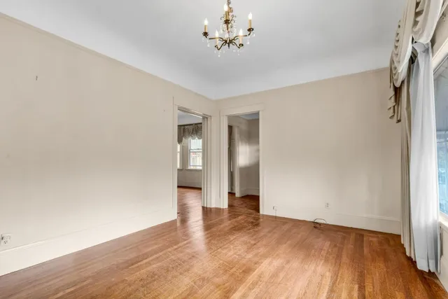 a view of a room with wooden floor and fireplace