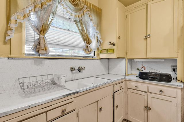 a kitchen with a sink and cabinets