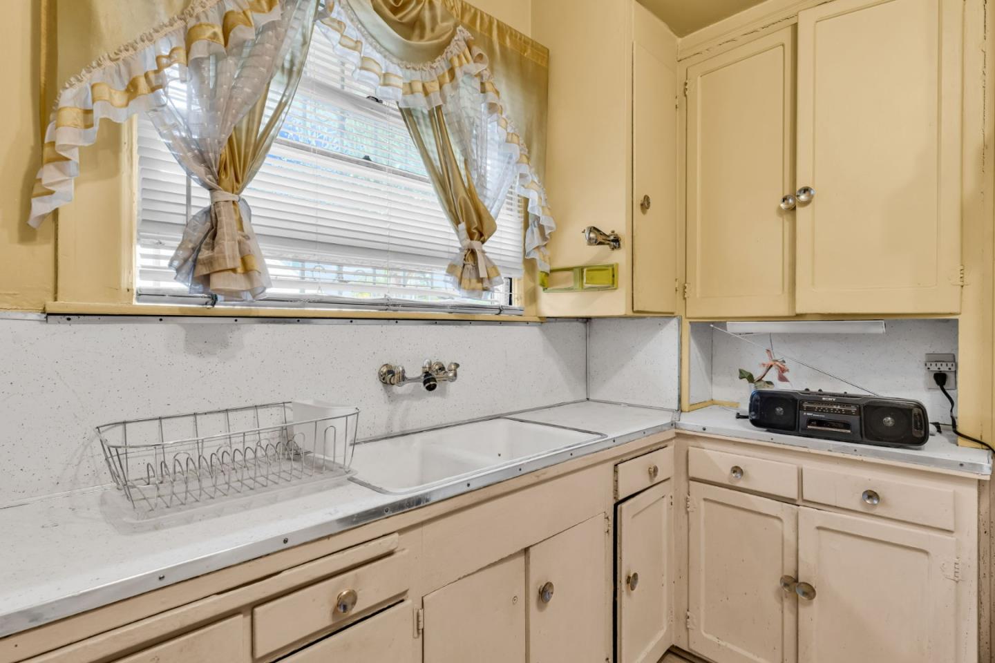 852 58th Street Oakland, CA 94608 - Photo 6 of 64 a kitchen with a sink and cabinets