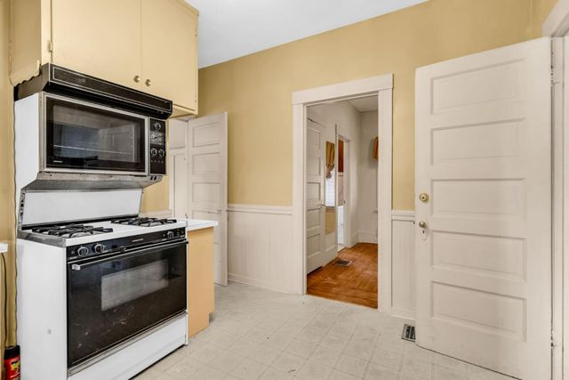 a kitchen with a stove and a microwave