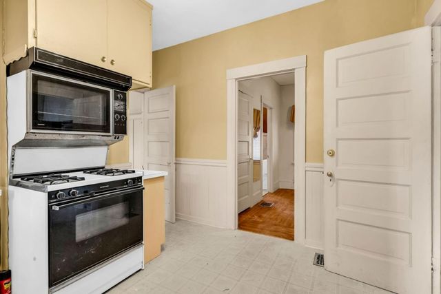 a kitchen with stainless steel appliances granite countertop a stove and a microwave