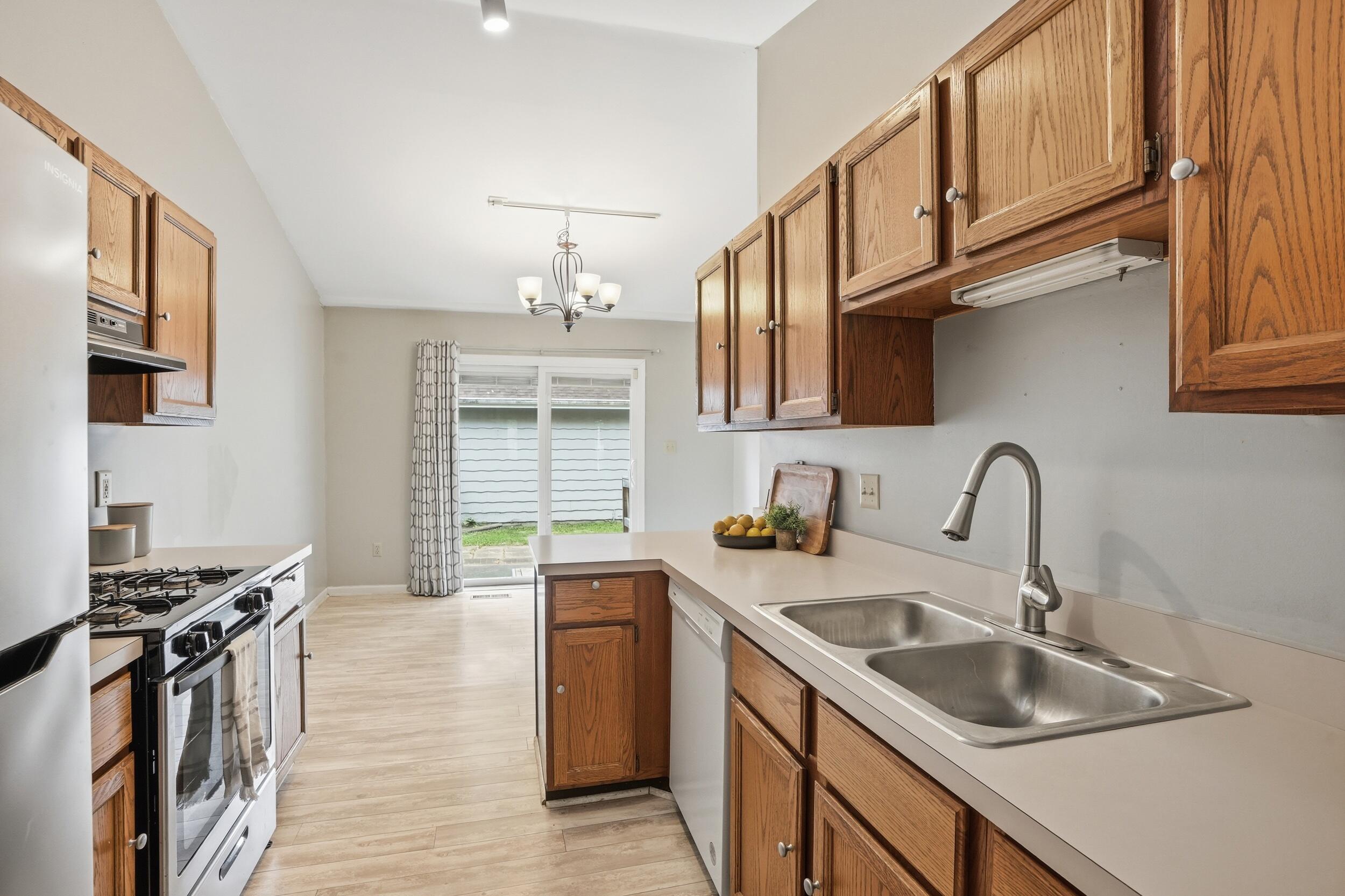 225 Clinton Street Lowell, IN 46356 - Photo 8 of 22 a kitchen with stainless steel appliances granite countertop a sink stove and cabinets