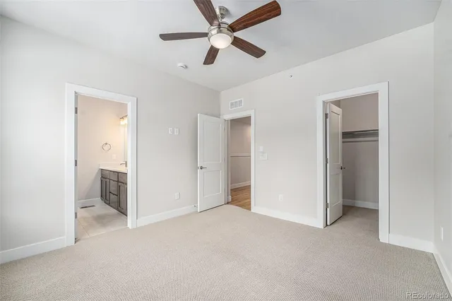 a view of empty room with ceiling fan